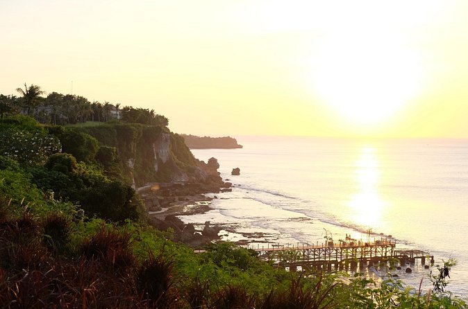 The south Bali coast at sunset, low cliffs running away to the west