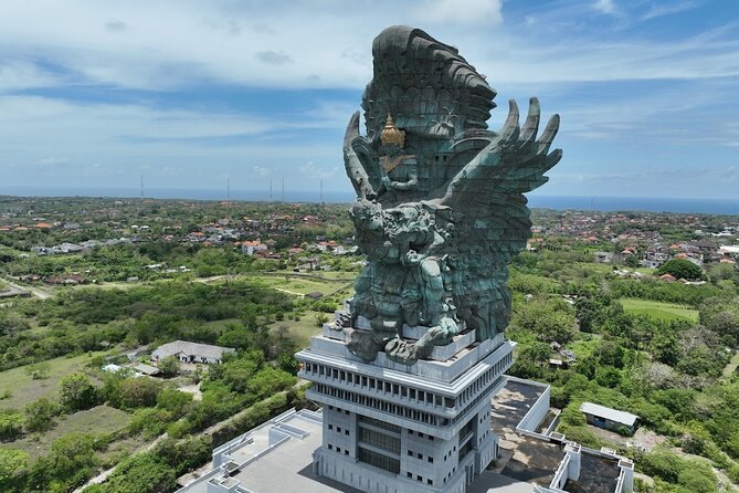 The Garuda Wisnu Kencana statue standing above the Bukit from the air